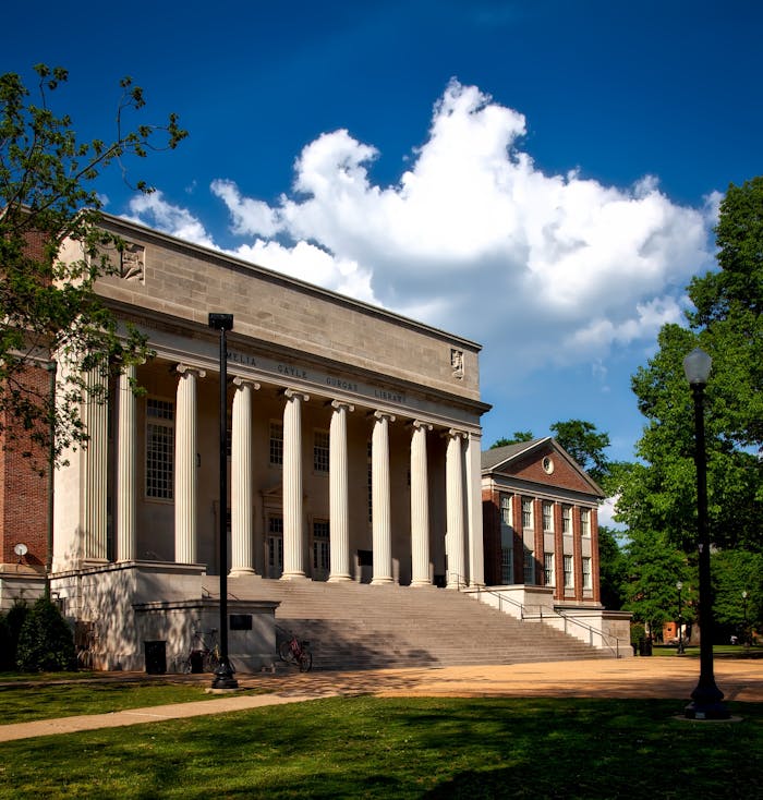 building-in-city-against-sky-256490 Historic neoclassical university library with columns on a sunny day.